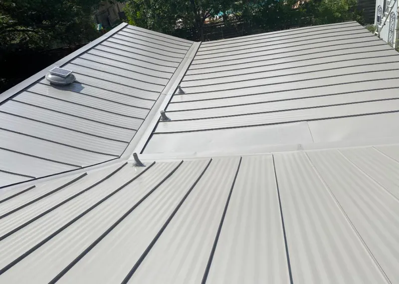 Solar attic fan installed on a metal roof for Roof Ventilation in East Hampton